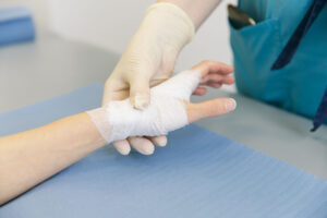 Orthopedic physician holding patient's bandaged hand